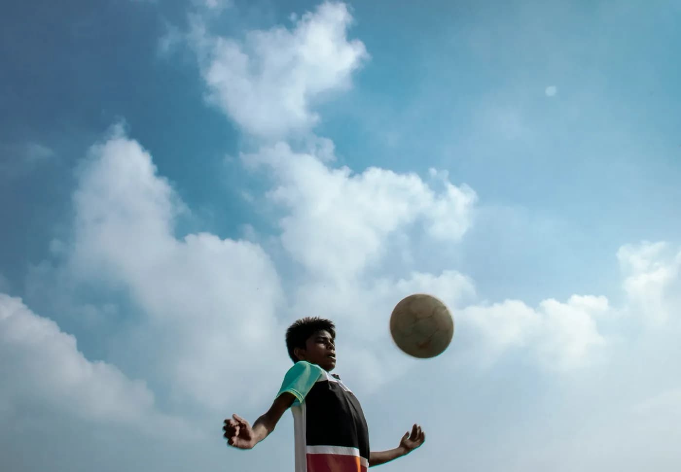 A young footballer heading the ball